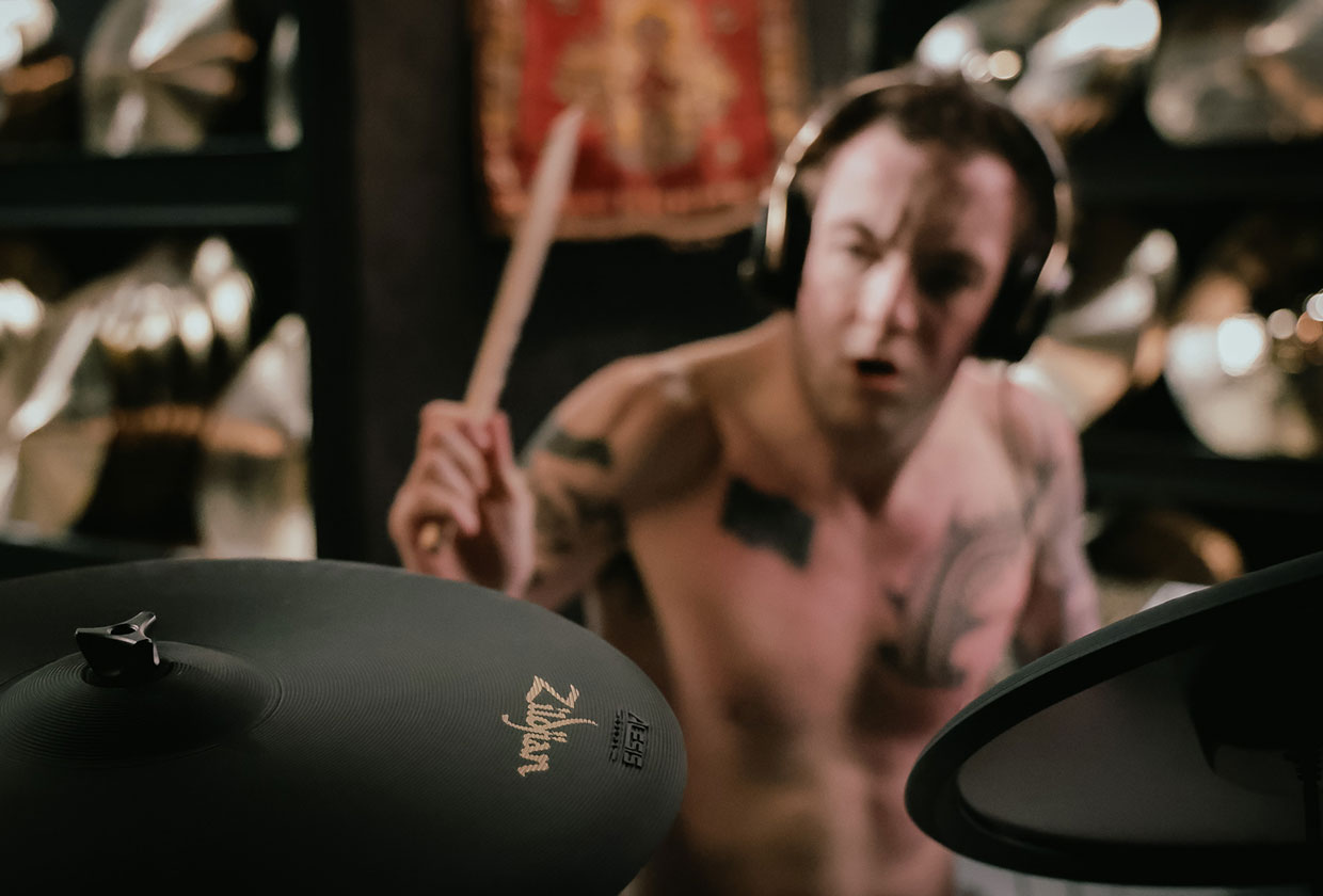 Drummer playing an Alesis Strata electronic drum kit fitted with Zildjian cymbals